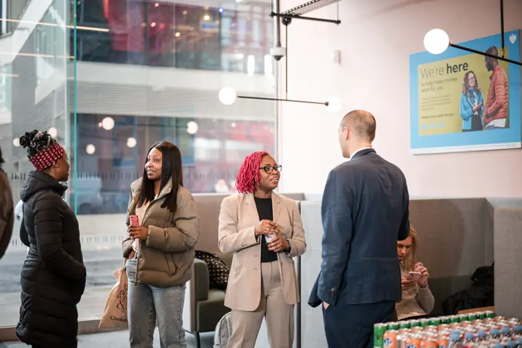 People meet beside the Foundervine welcome sign.