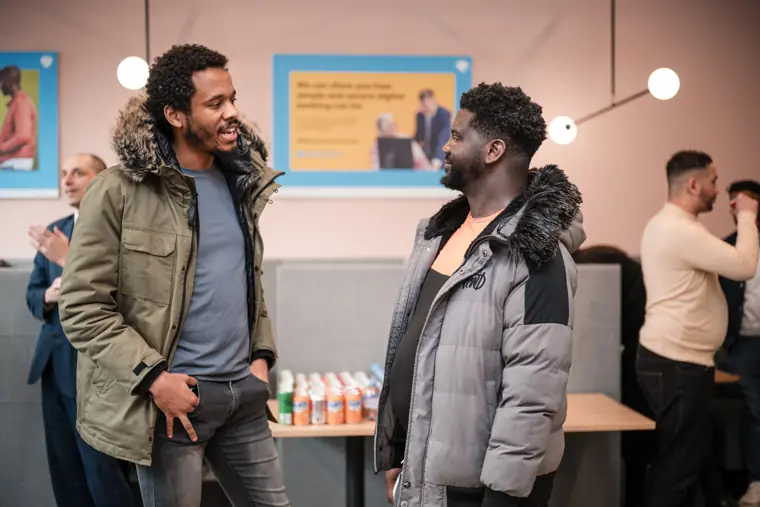A founder greets another participant at the reception.