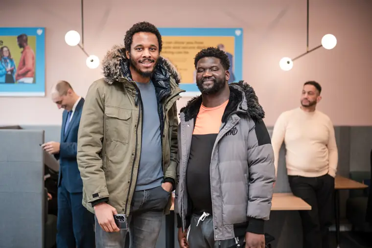 Two attendees pose together during the event.