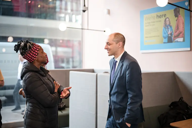 An attendee talks with a Barclays team member.