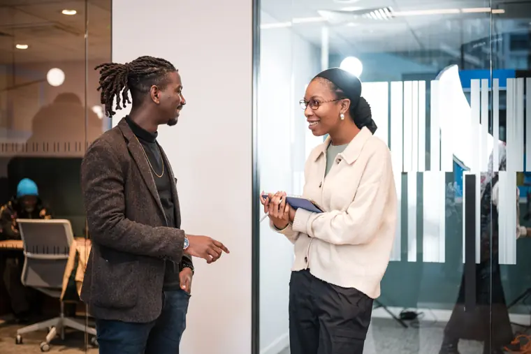 Two founders exchange views in the networking area.