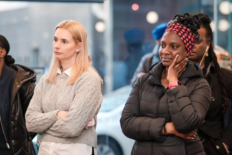 Two guests listen to a question from the room.
