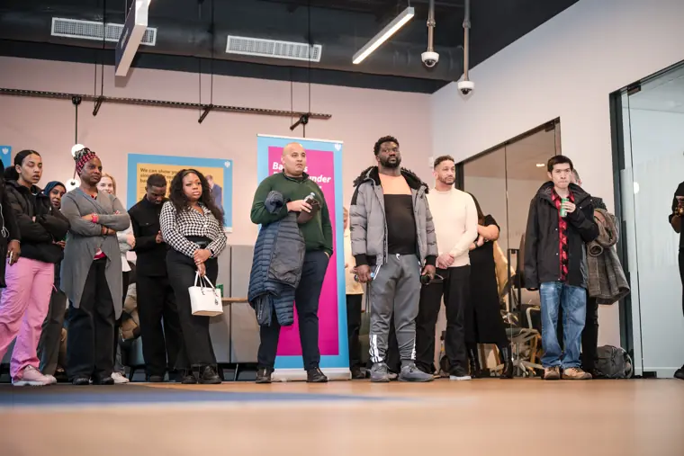 Attendees watch a conversation on stage.