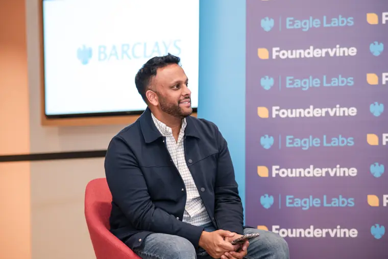A panellist speaks in front of the Foundervine backdrop.
