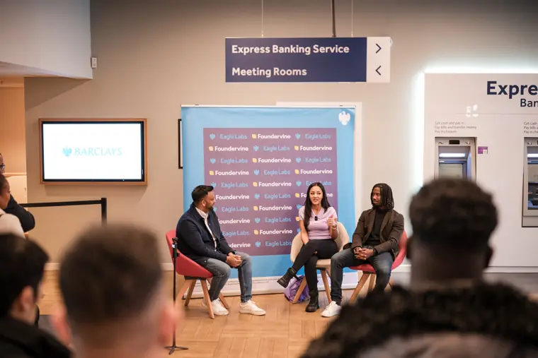 A wide view of the panel and seated guests.