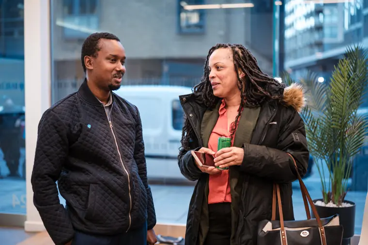 Two attendees pause for a portrait by the windows.