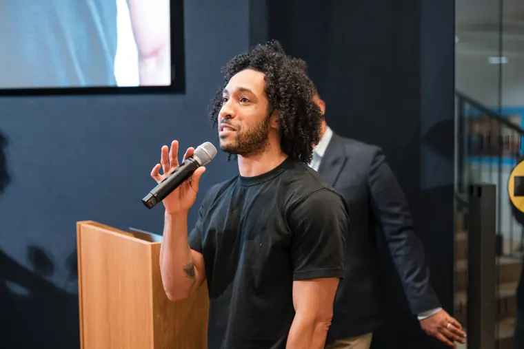 A founder pitches beside the presentation screen.