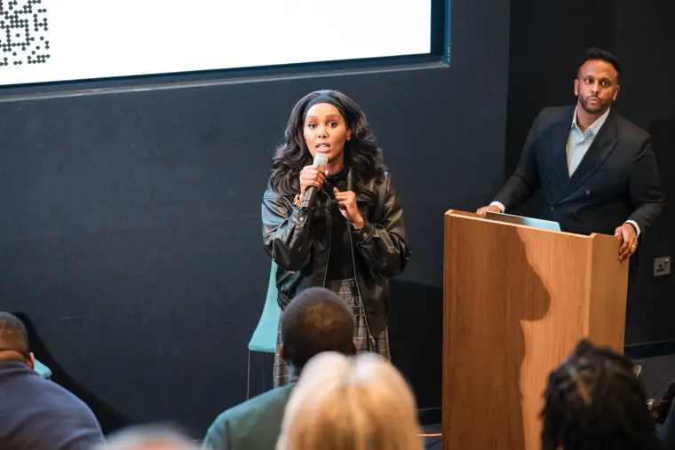A founder addresses attendees on stage.