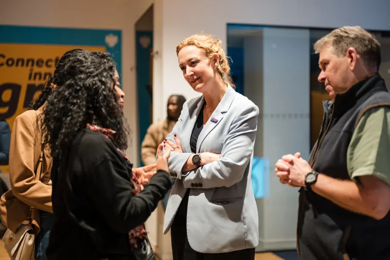 Guests exchange ideas at the reception.