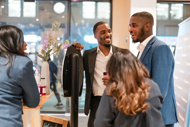 Two attendees enjoy a conversation.