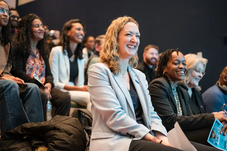 An audience member reacts to a speaker.