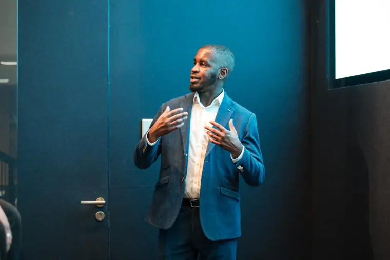 A speaker addresses the audience.