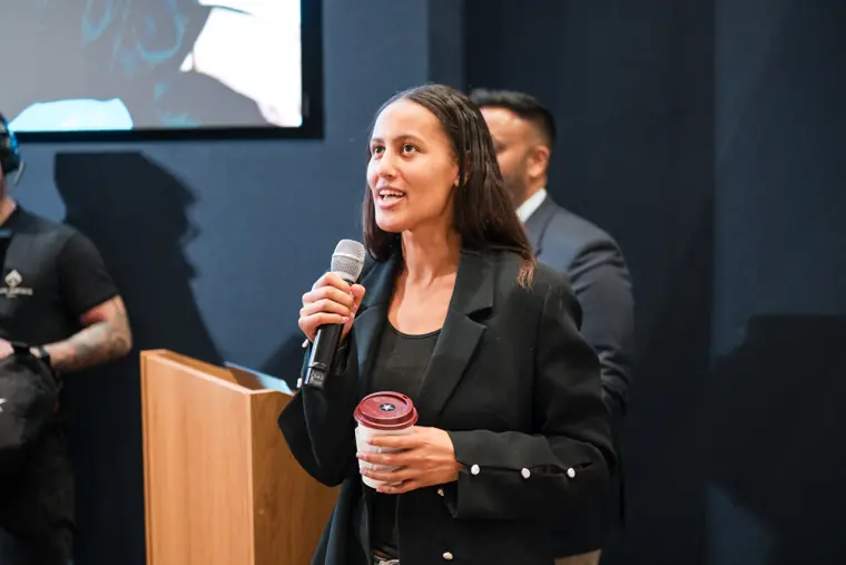 A presenter answers a question on stage.