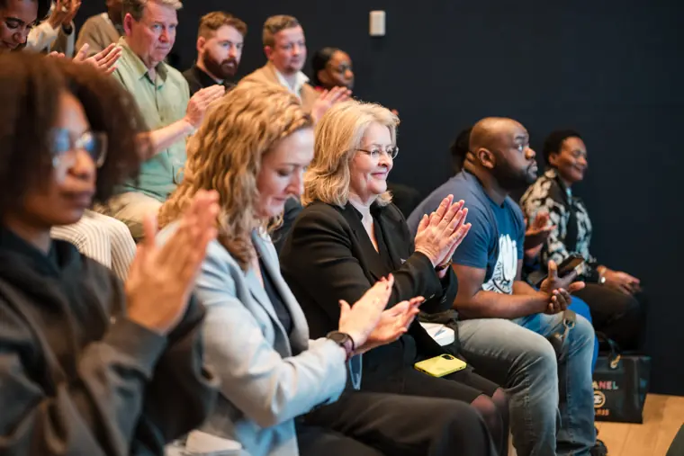 Attendees applaud the pitch presentations.