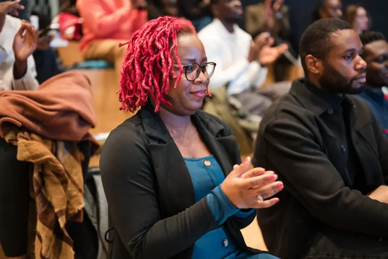 A guest applauds a founder pitch.