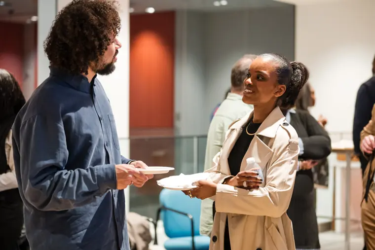 A founder speaks with another attendee.