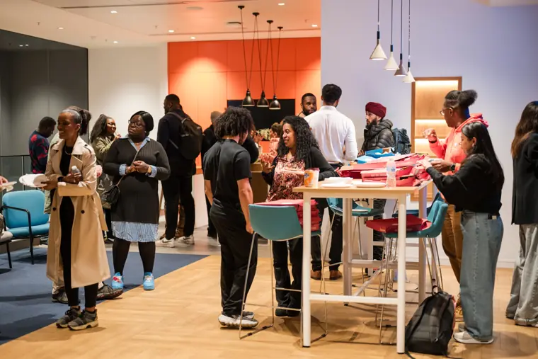 Attendees connect around the welcome table.