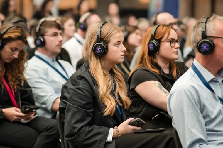 Attendees listening to a stage discussion.