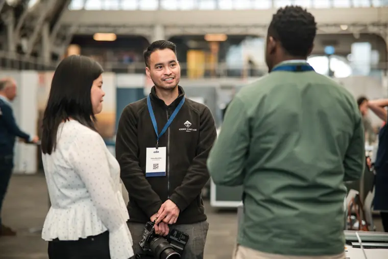 Attendees connecting on the exhibition floor.