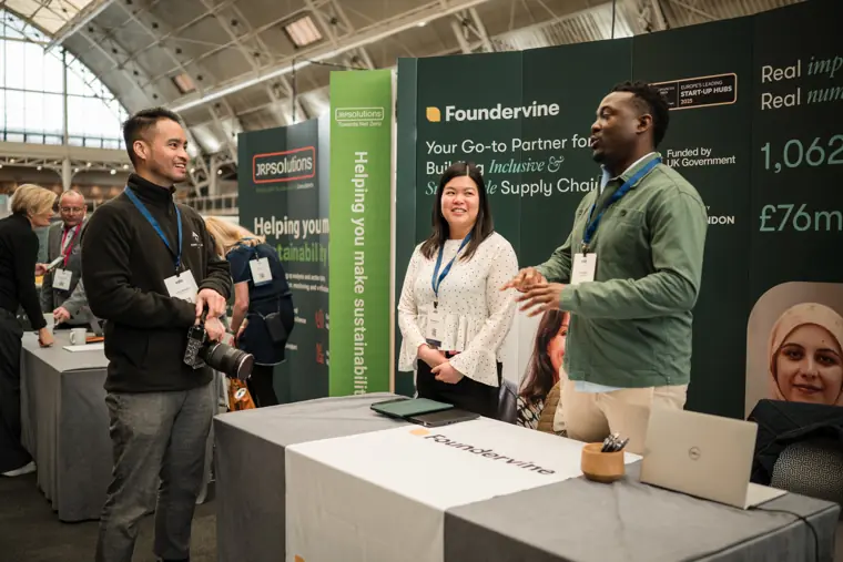 Foundervine team speaking with a visitor.