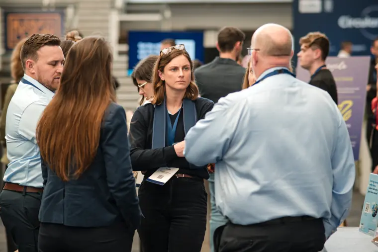 Delegates in conversation at the exhibition.