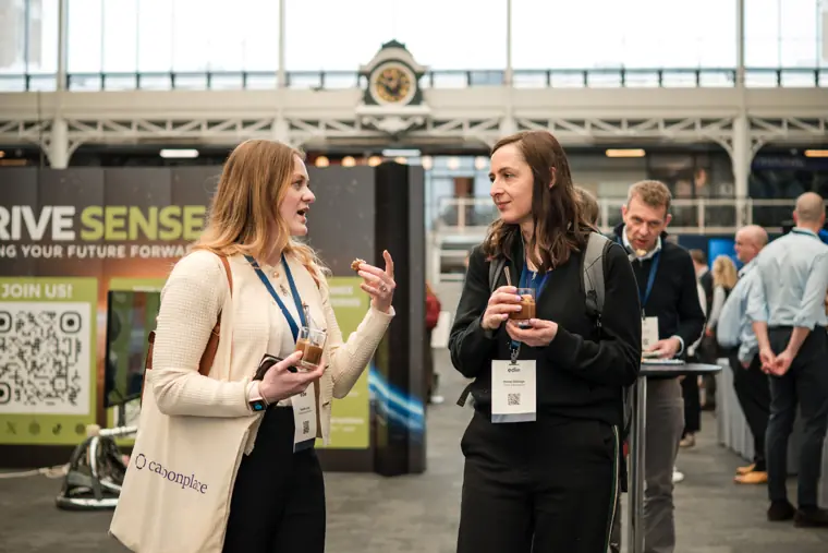 Delegates talking in the exhibition hall.