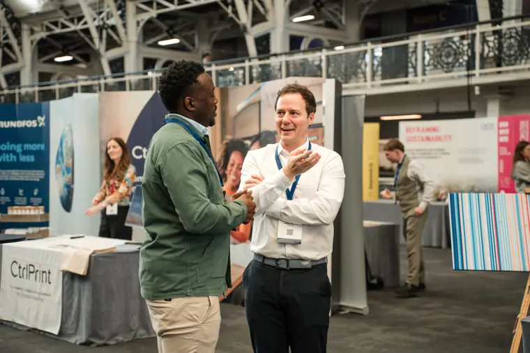 Foundervine representative talking with a visitor.