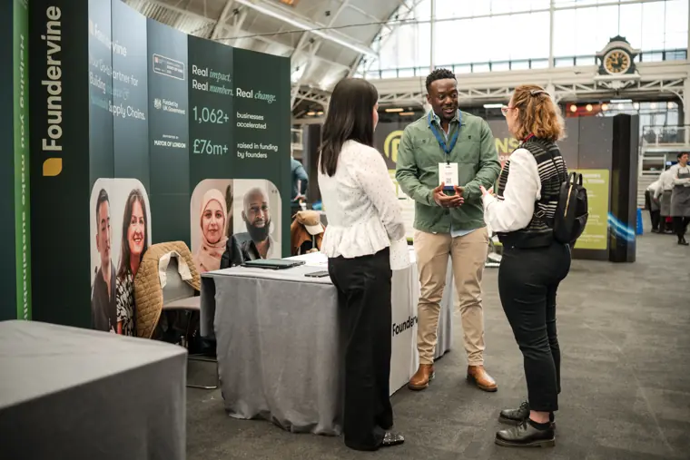 Foundervine team together at their booth.