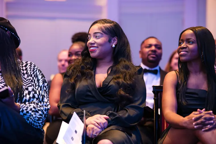 Guests watch the stage from the front rows.