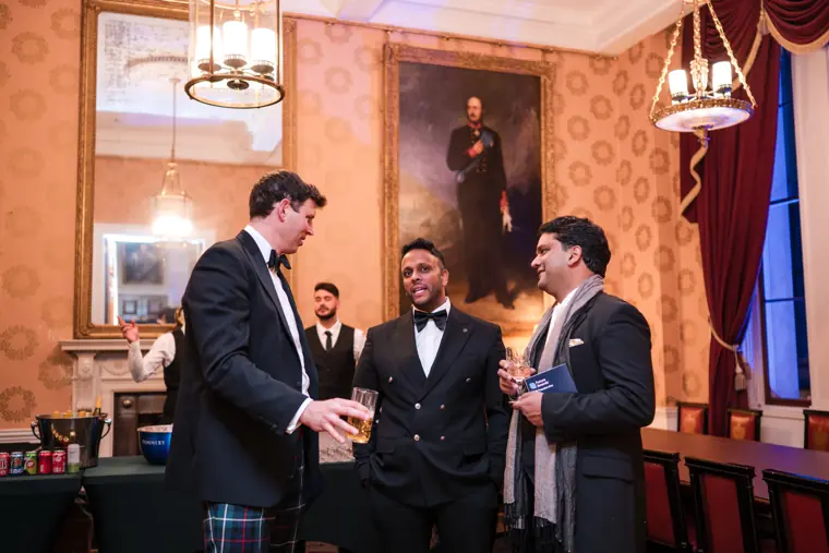 Three attendees talk during the reception.