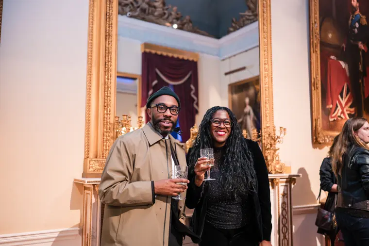 Two guests pause for a reception photograph.