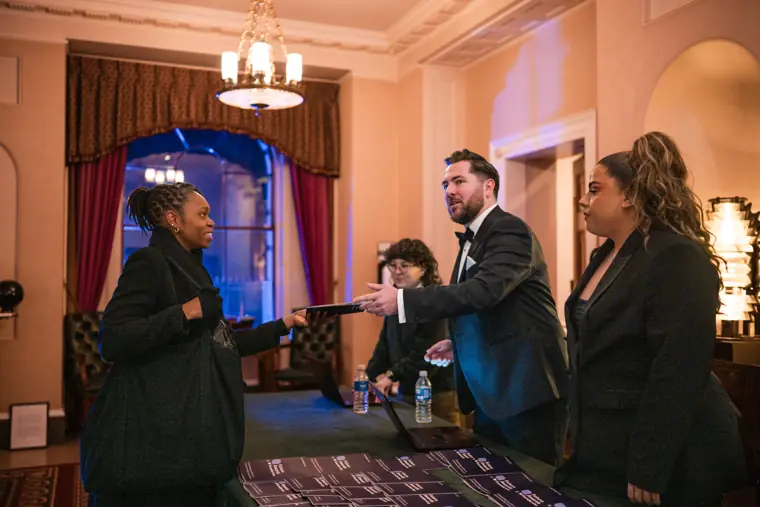 Guests arrive and greet each other at the reception.