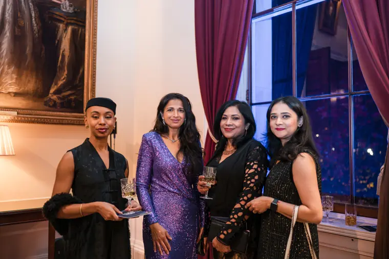 Four guests pose together during the reception.