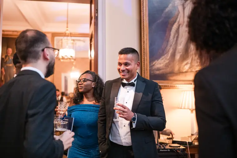 Two attendees speak in the reception space.