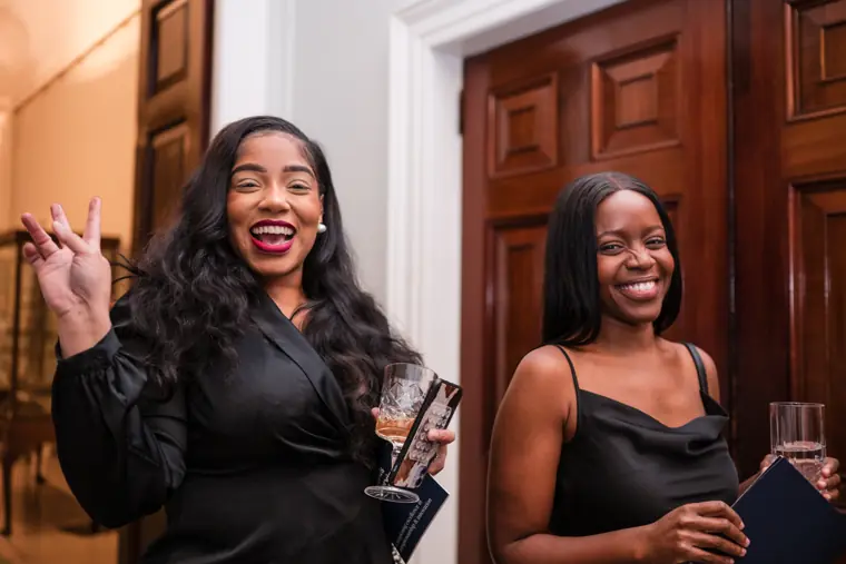 Two guests greet the photographer at the doorway.
