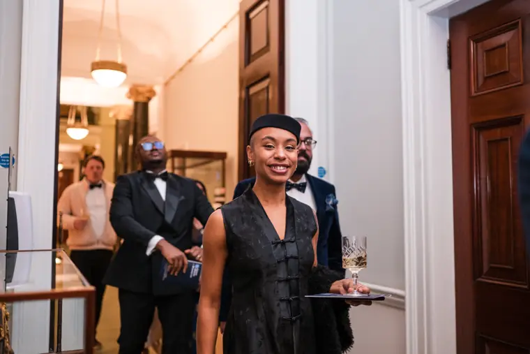 A guest smiles as she arrives.
