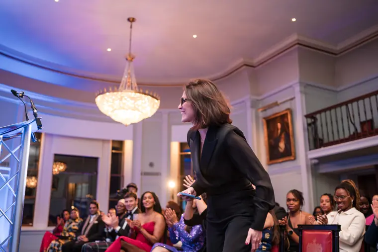 Audience members respond to a speaker.