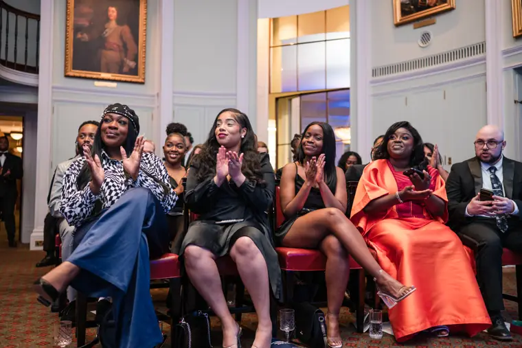 Guests react from the front rows.