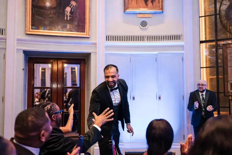 A recipient approaches the stage.