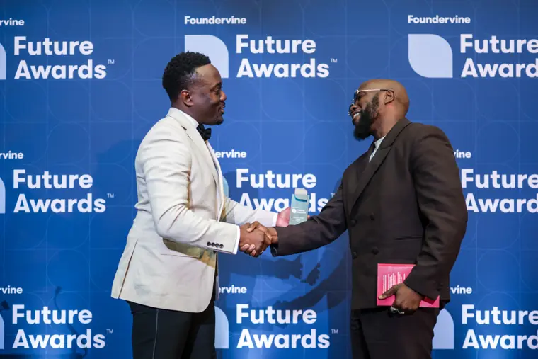 An award handover between two presenters.