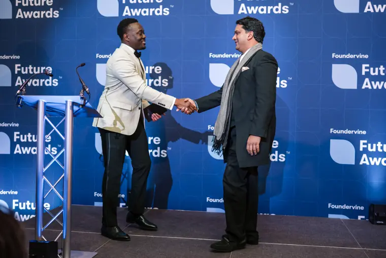 A winner accepts an award on stage.
