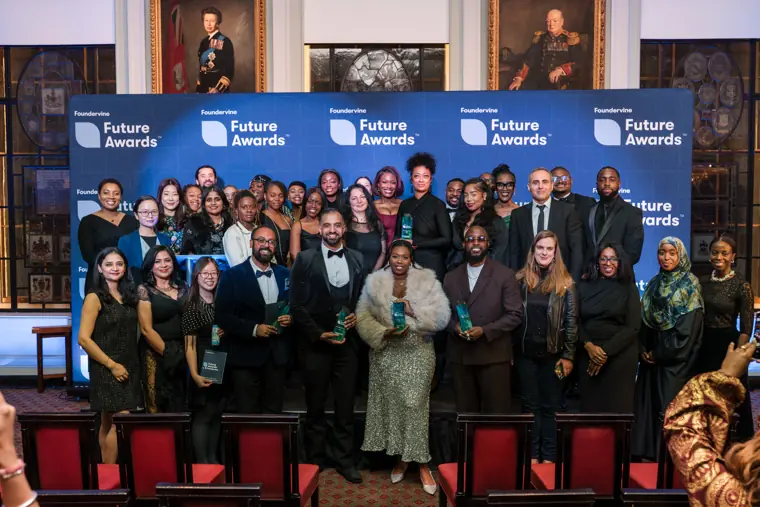 A large group gathers for a stage photograph.