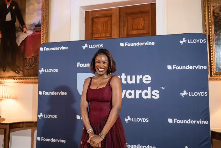 A guest smiles against the Future Awards branding.