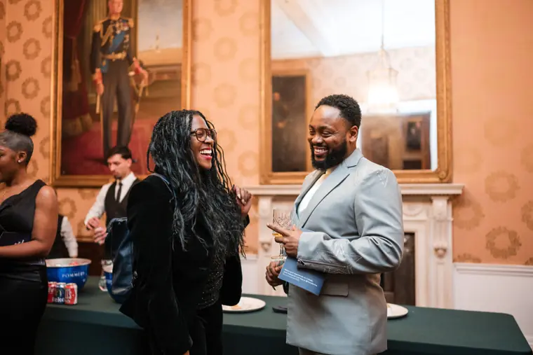 Two attendees catch up after the ceremony.