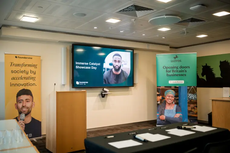 The prepared lectern and Immerse Catalyst presentation screens before guests arrive.