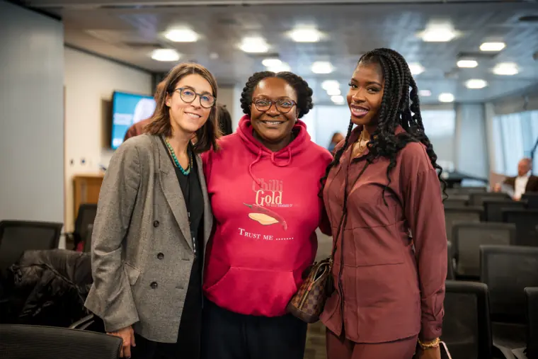 Three attendees pose together after the programme.