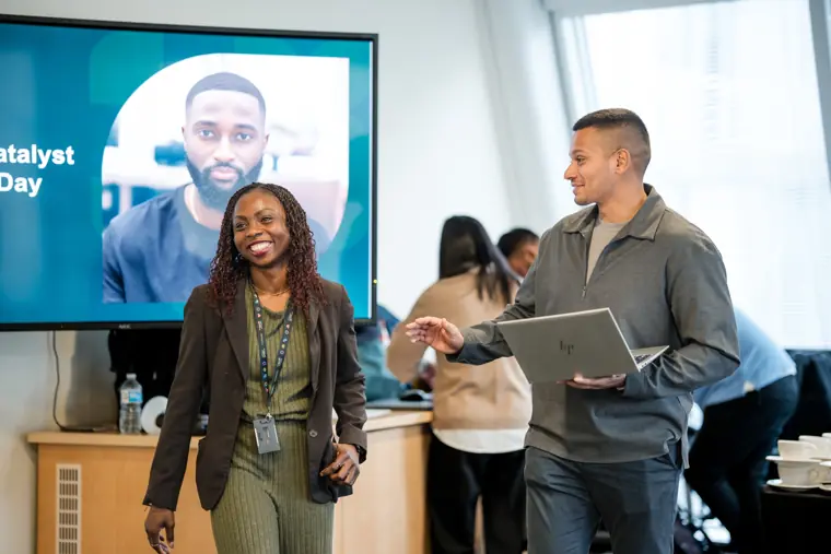 Guests exchange views beside the showcase screen.
