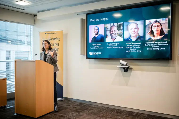 A founder presents to the seated audience.
