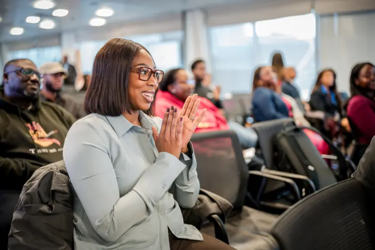An attendee applauds during a showcase presentation.