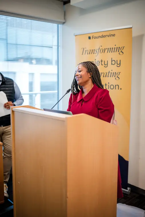 A speaker talks at the Foundervine lectern.